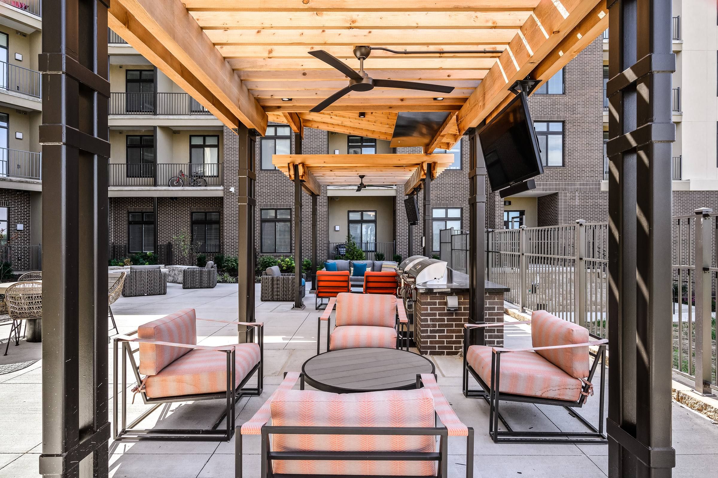 The District Flats apartments community outdoor patio with wood awning and comfortable seating