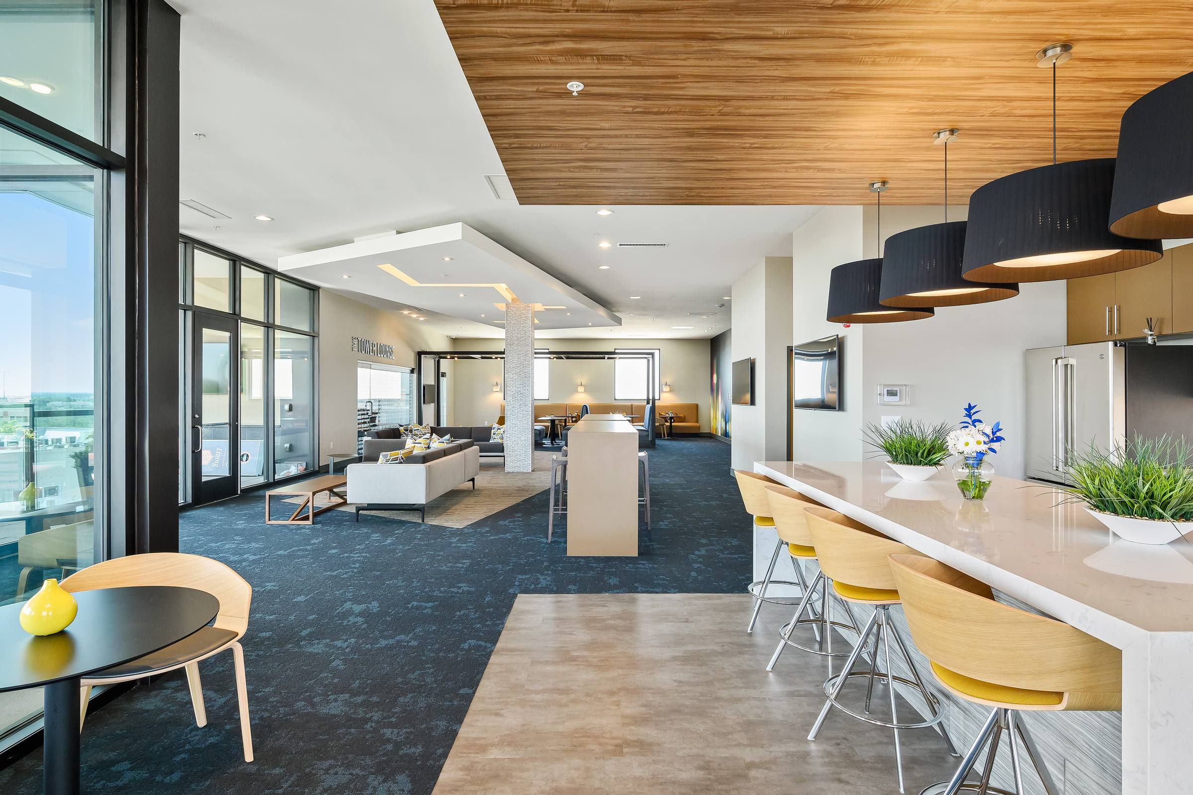 The District Flats apartment community kitchen and seating area in Tower Lounge with modern finishes