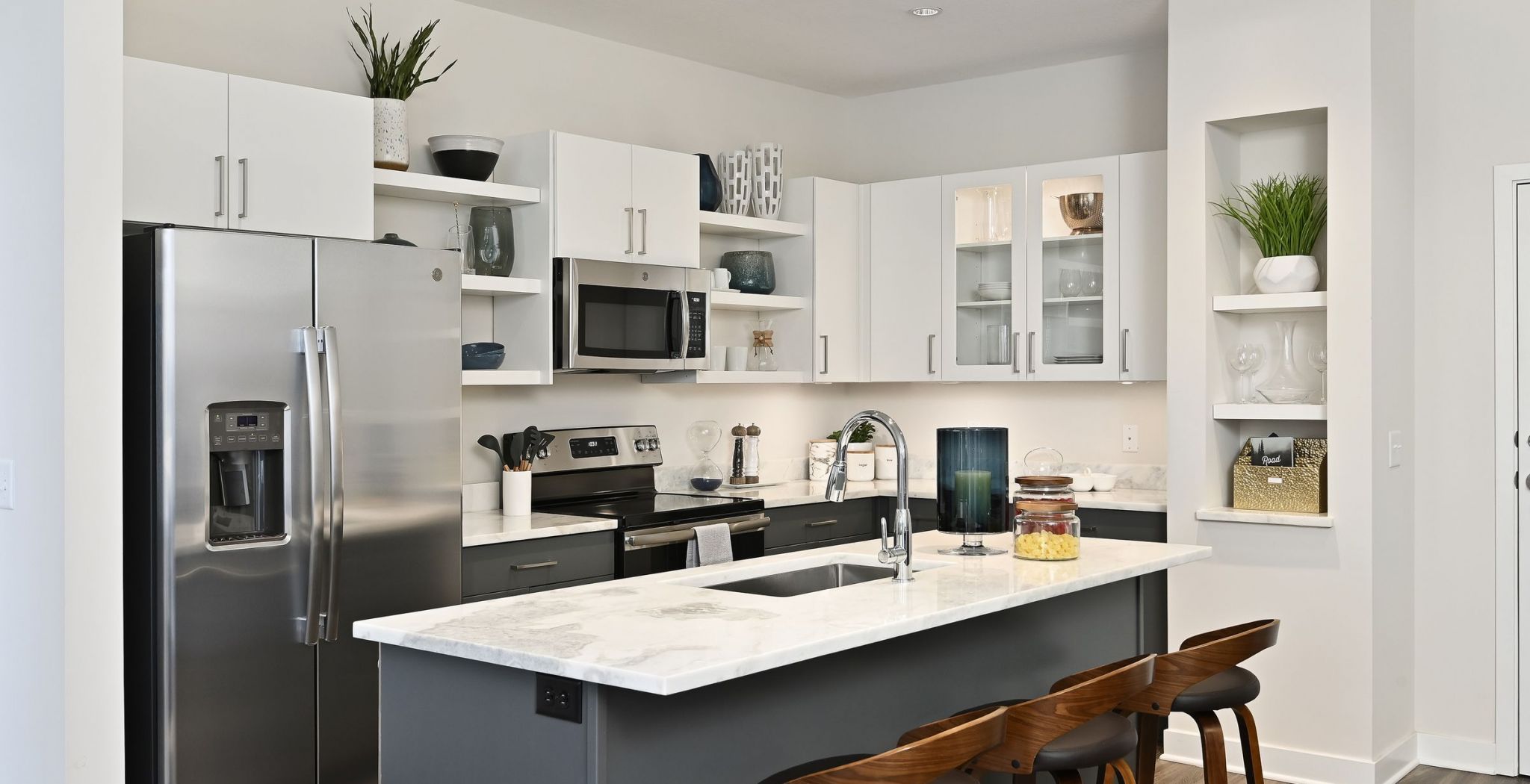 District Flats apartment kitchen with quartz counter tops and white custom cabinets